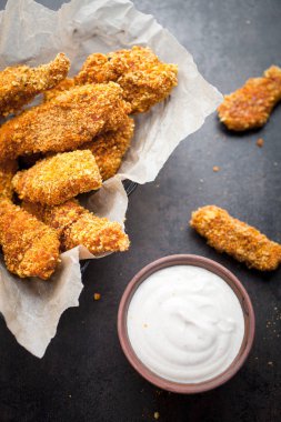 Homemade chicken fingers and dip sauce clipart