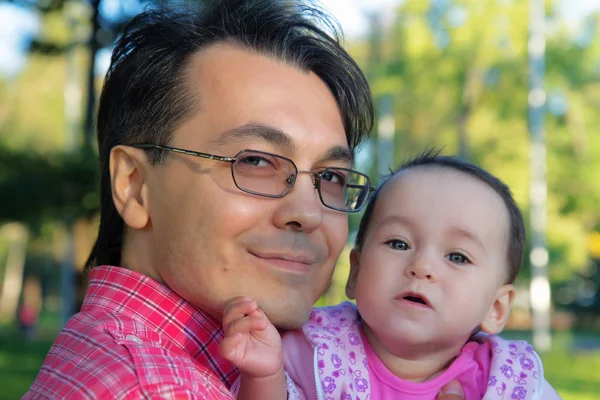 Portrait rapproché de bébé fille tout-petit sur les bras de papa . — Photo