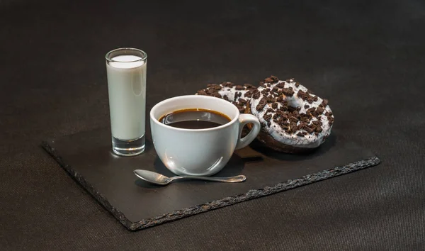 Left view on an aromatic black coffee in a white cup with coconu — Stock Photo, Image