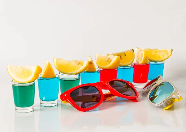 Glasses with blue, green and red kamikaze, glamorous drinks, mix — Stock Photo, Image