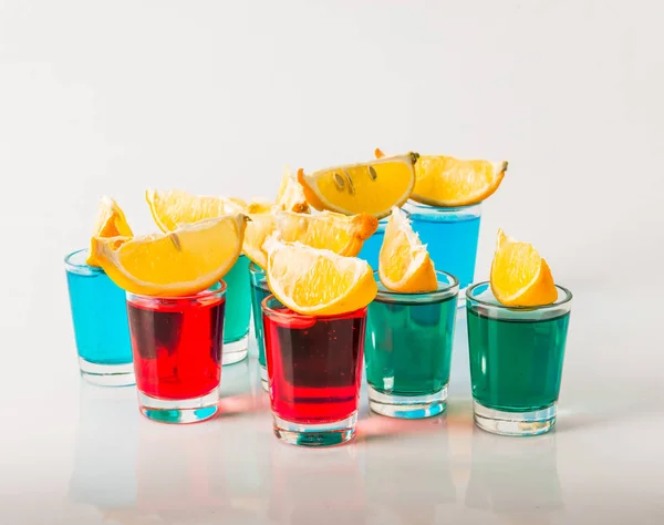 Glasses with blue, green and red kamikaze, glamorous drinks, mix — Stock Photo, Image