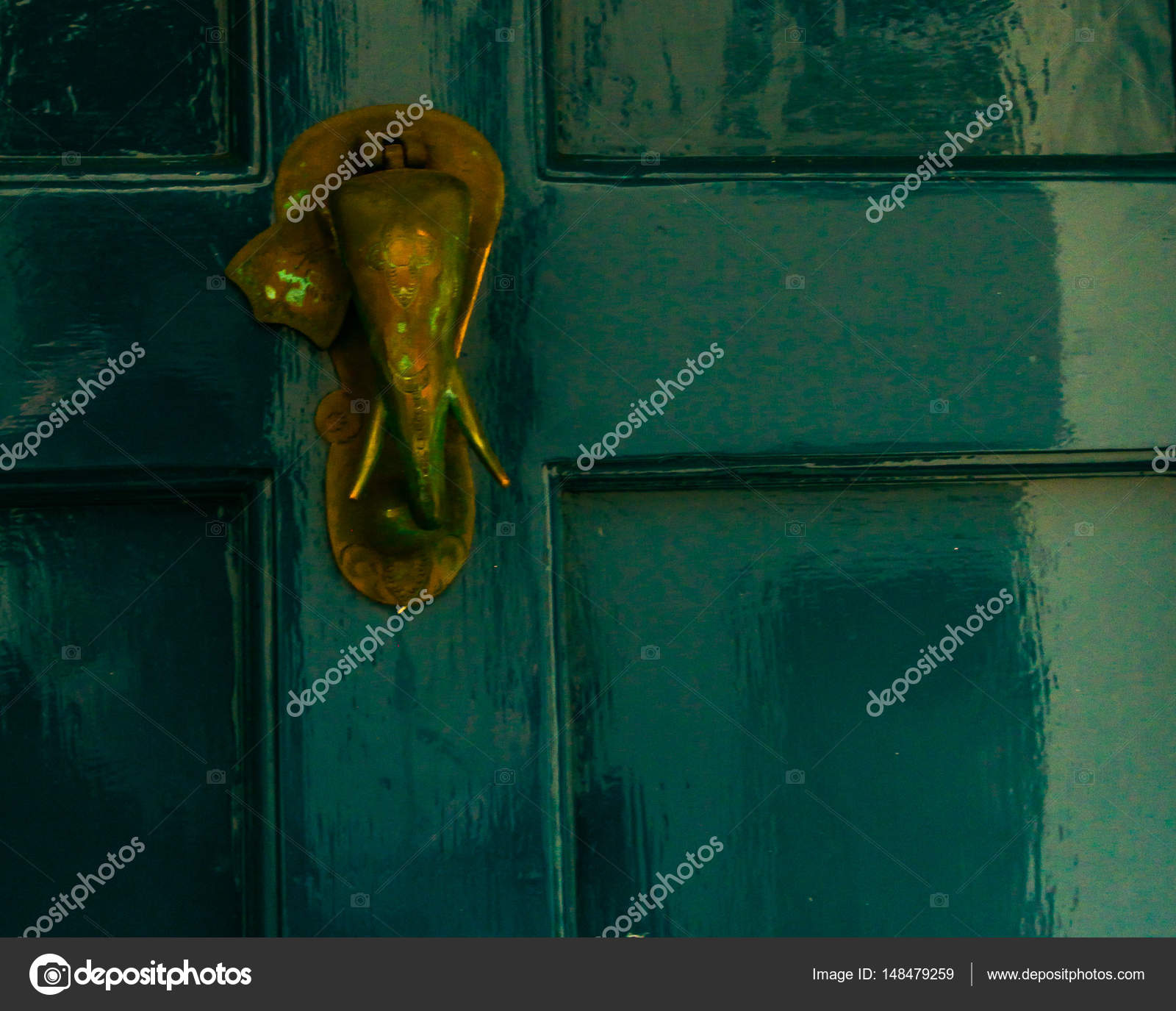 Old Ruined Brass Elephant Head Knocker On The Green Door