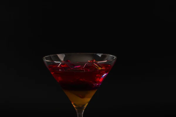 Bebida colorida en una copa de cóctel, con cubitos de hielo, bebida de verano — Foto de Stock