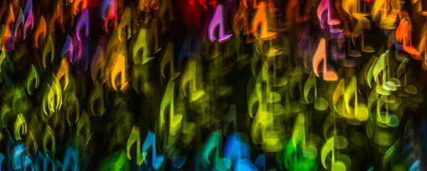 Night lights bokeh shaped sheet music, defocused bokeh light, bl — Stock Photo, Image