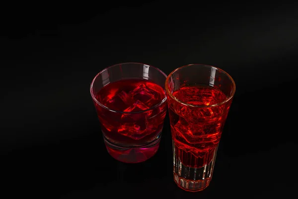 Colorful drink in a cocktail glass, with ice cubes, summer drink