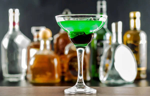 Băutură colorată pe fundalul sticlelor în forme originale , — Fotografie, imagine de stoc