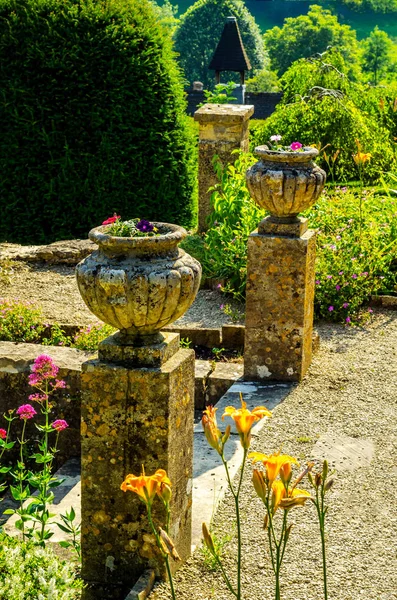 Concrete flower pots in the garden on a pedestal stylized antiqu — Stock Photo, Image