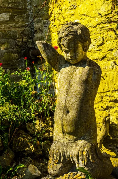 Old sculpture on the pedestal, beautifully preserved old artisti