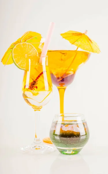 Colorful cocktail decorated with scorpion, colorful umbrella, ic — Stock Photo, Image
