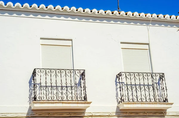 Stylish balcony with a metal railing, solid architectural elemen