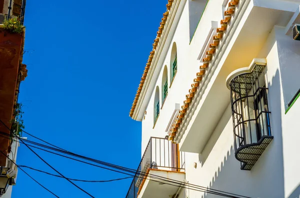 Stylish balcony with a metal railing, solid architectural elemen