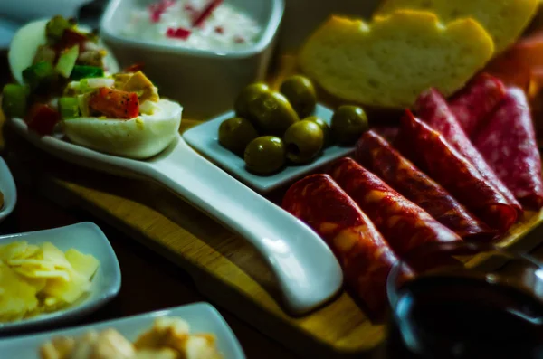 Board of meats and other starters, a variety of small dishes, a — Stock Photo, Image