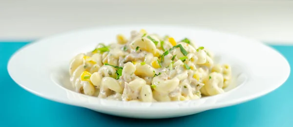 Cooked pasta with flaked tuna and sweetcorn in mayonnaise dressi