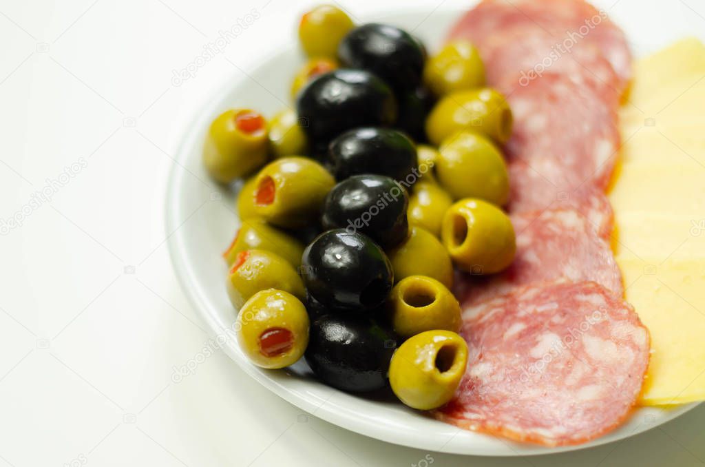 Set green and black olives with salami and cheddar cheese