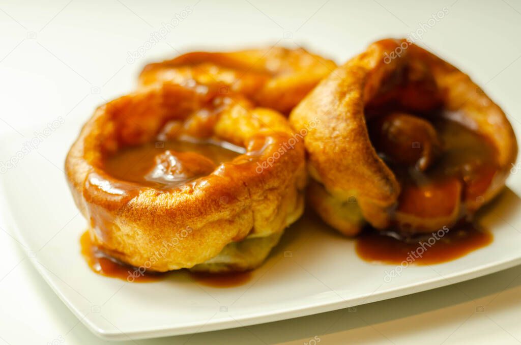 Traditional English Yorkshire pudding with meatballs and thick gravy sauce, english food