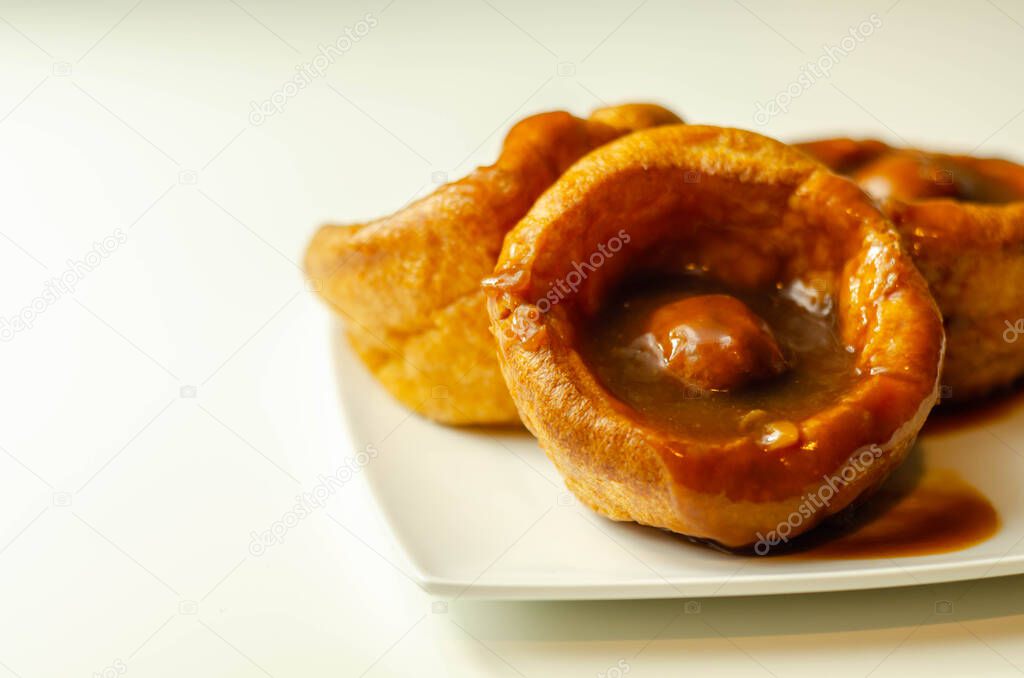 Traditional English Yorkshire pudding with meatballs and thick gravy sauce, english food