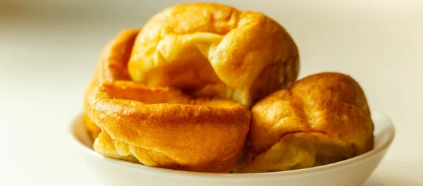 Traditional English Yorkshire pudding, wonderfully crisp and golden baked for a traditional recipe, accompaniment for the perfect Sunday roast, English food