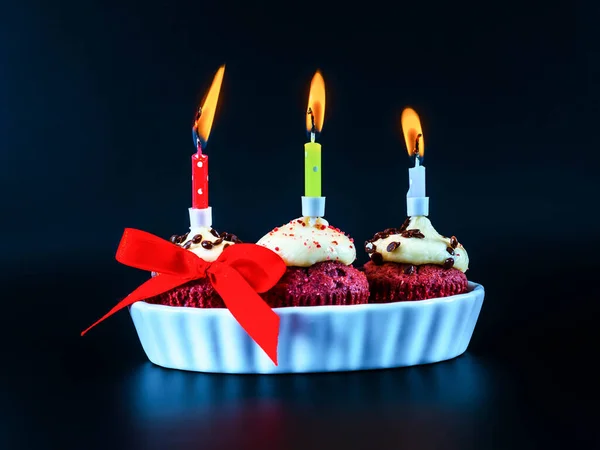 Sweet colorful mini cupcakes with burning candles, the celebration of an important day, delicious sweets