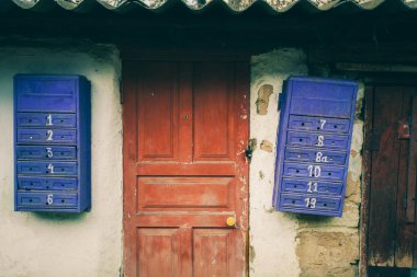 Birkaç eski posta kutuları duvarda asılı. Paslı posta kutuları. Geçmişten gelen posta