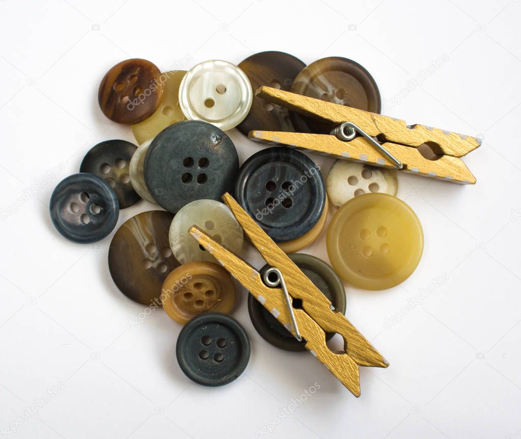 Pile of Assorted Colorful Buttons and Wooden Clothes Pins Isolat