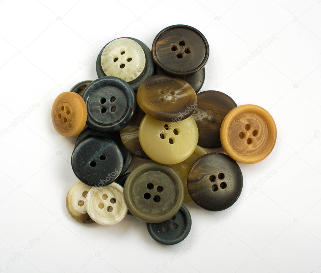 Pile of Assorted Dark Buttons Isolated on White