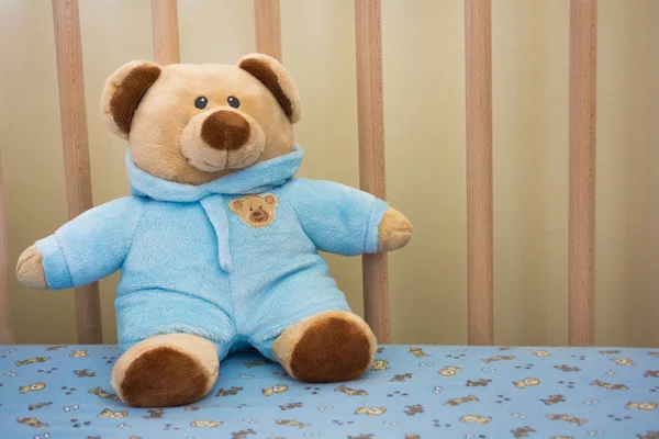 Cute Teddy Bear Stuffed Animal in a Baby Crib — Stock Photo, Image