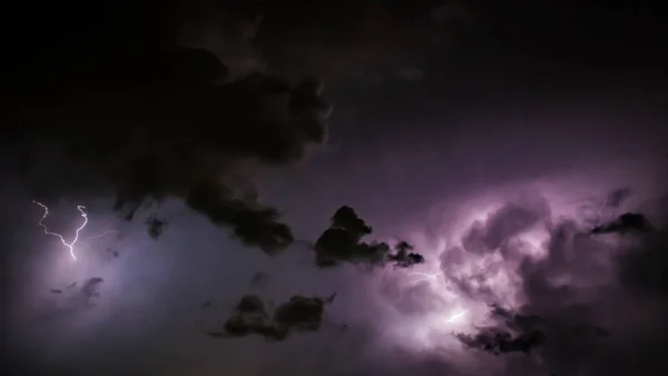 Lightning Bolt Discharges in Purple Storm Clouds at Night — Stock Photo, Image