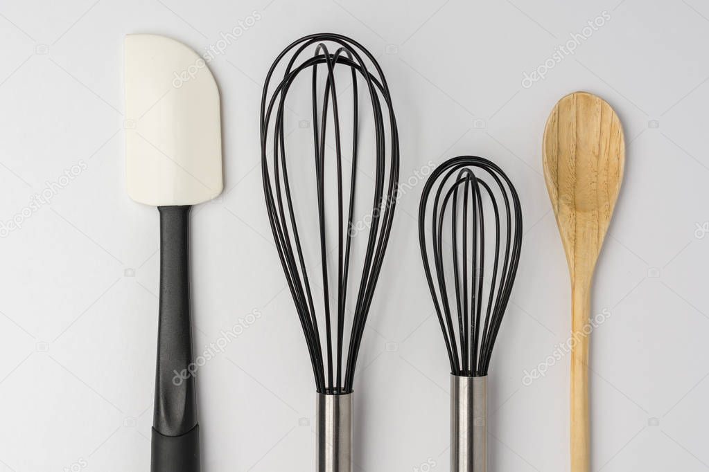 Assorted Kitchen Utensils on White Background Cropped Close Top 