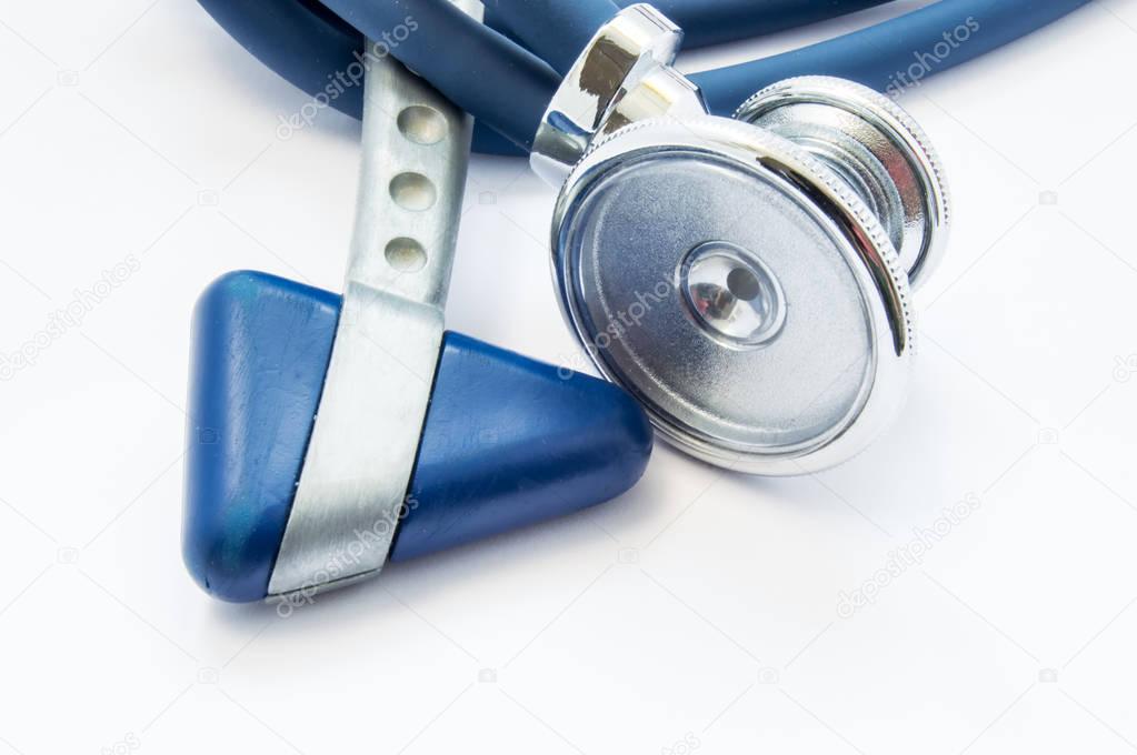 Blue stethoscope and neurological hammer closeup on white background as medical tool for preparation or conduct physical examination of patient by physician for presence of diseases and pathologies