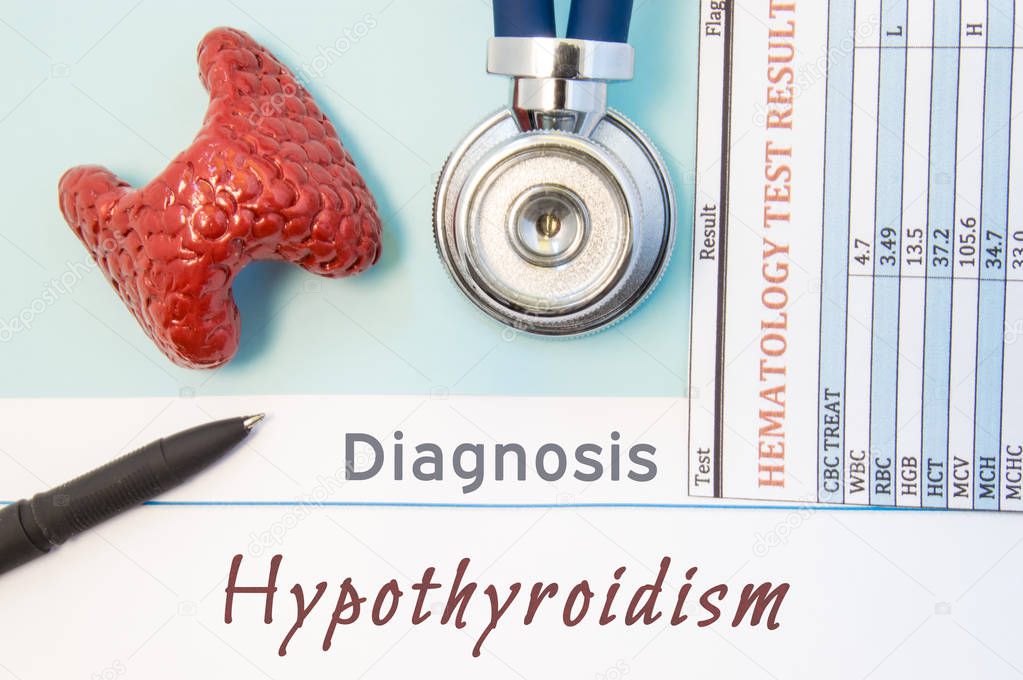 Endocrinology diagnosis Hypothyroidism. Figure of thyroid gland, result of laboratory analysis of blood, medical stethoscope and black pen lying near text inscriptions Hypothyroidism doctor workplace
