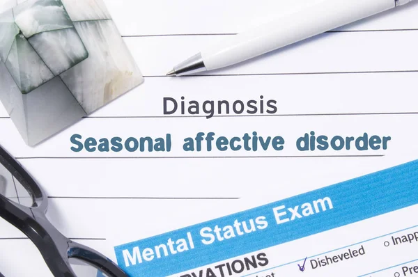 Psychiatrische diagnose Seasonal Affective Disorder. Medische boek of vorm met de naam van de diagnose Seasonal Affective Disorder is op tafel van dokter omgeven door vragenlijst om te bepalen van de mentale toestand — Stockfoto