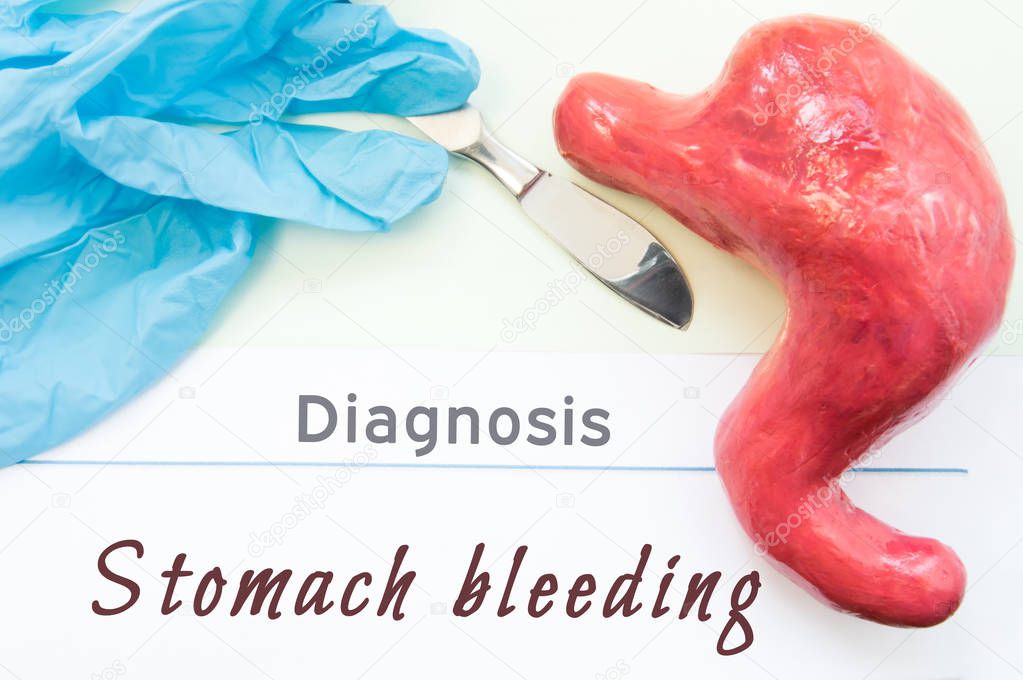 Diagnosis of Stomach Bleeding. Figure stomach, scalpel and surgical gloves lie near title Diagnosis Stomach Bleeding. Concept photo of causes, symptoms, diagnostic, treatment and diet 