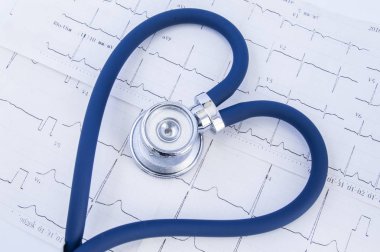 Heart formed stethoscope against background of electrocardiogram (ekg). Head or chestpiece and flexible tubing of blue stethoscope folded into heart shape, which lies on printed electrocardiogram  clipart