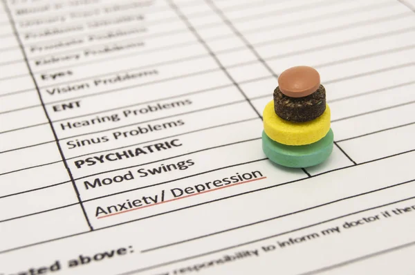 Pills pyramid on sheet of health history near words anxiety, depression, psychiatric symbolizing recovery, tranquility, calmness, composure in treatment of these psychiatric disorders or diseases — Stock Photo, Image