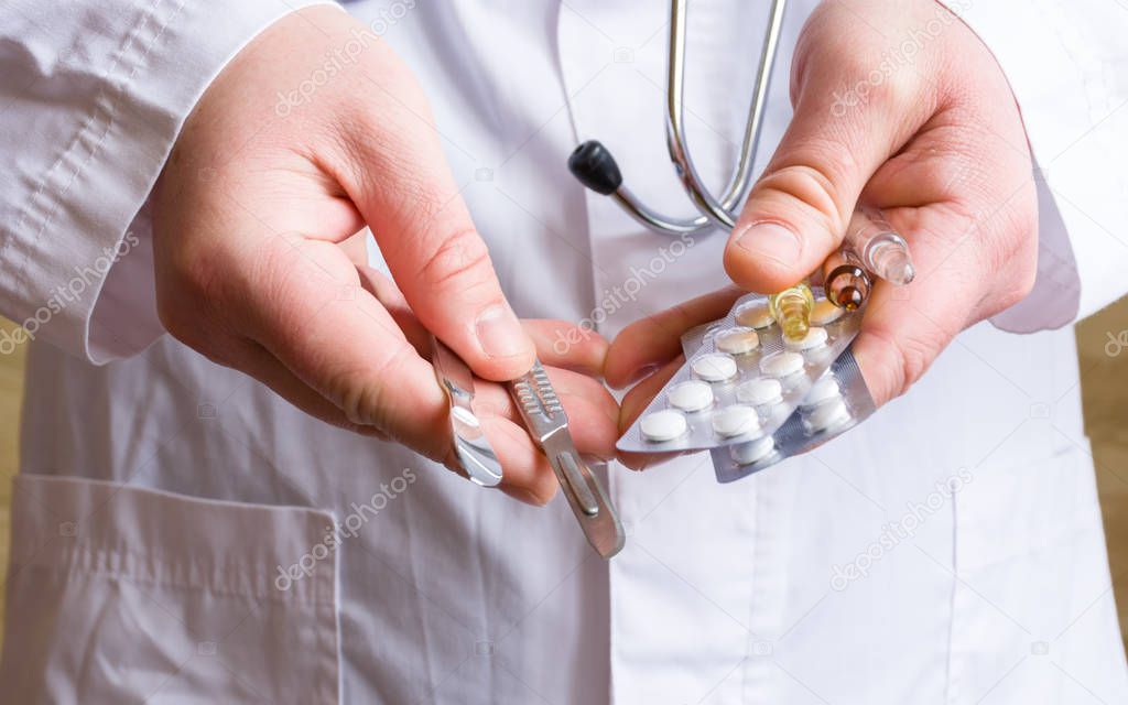 Concept photo choice or strategy for treating patient - surgical (operation) or therapeutic (with medications). Doctor holds surgical scalpels in one hand, in another - pills in blisters and ampoules