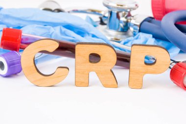 Abbreviation or acronym of CRP, in laboratory, scientific, research or medical practice means C-reactive protein, is in foreground with laboratory test tubes, medical stethoscope and gloves clipart