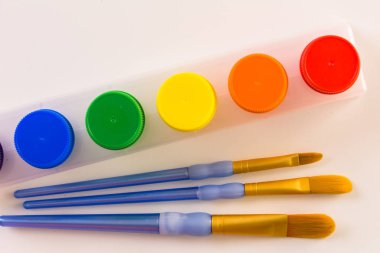 Boya ve beyaz bir arka planda fırçalar.