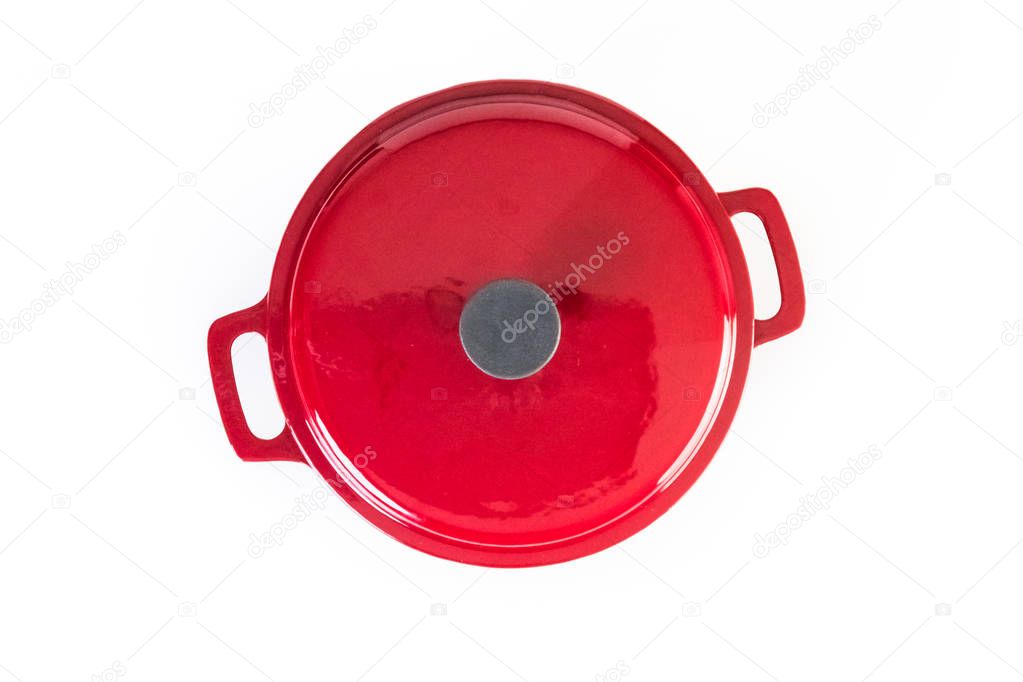 Red enameled cast iron covered dutch oven on a white background.