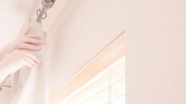 Hanging curtains in bedroom — Stock Photo, Image