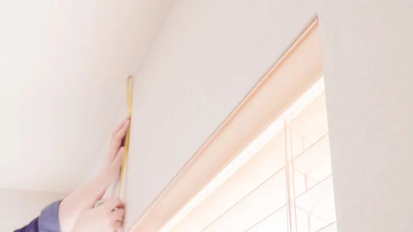 Hanging curtains in bedroom — Stock Photo, Image