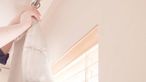 Hanging curtains in bedroom — Stock Photo, Image