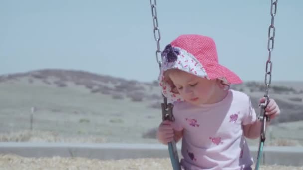 郊外の近所で屋外の子供用遊び場で遊ぶ少女 — ストック動画