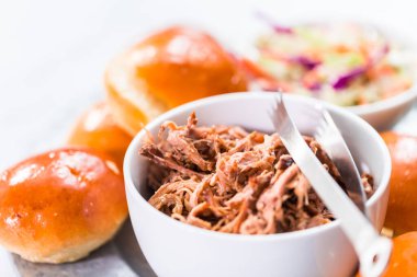 Barbekü, brioche çörekleriyle küçük hamburgerler şeklinde domuz sandviçi çekti..
