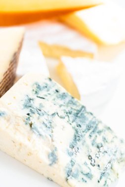 Beyaz arkaplanda geniş kama gurme peyniri çeşitliliği.