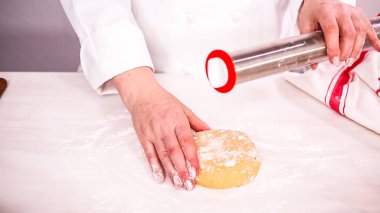 Adım adım. Metal oklava ile şeker kurabiye hamuru haddeleme.