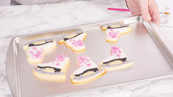Brushing Edible Glitter Iced Figure Skate Sugar Cookies — Stock Photo, Image