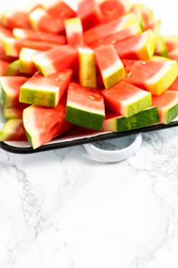 Parti için tepside küçük kırmızı çekirdeksiz karpuz dilimleri.