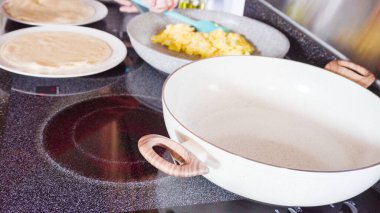 Un tortilla içinde taze sebze, yumurta ve pastırma ile kahvaltıda burrito pişirmek..