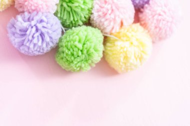 Pembe arka plan üzerinde pastel renk ponpon.
