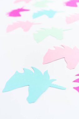 Beyaz arkaplanda renkli tek boynuzlu at kağıt kesitleri.